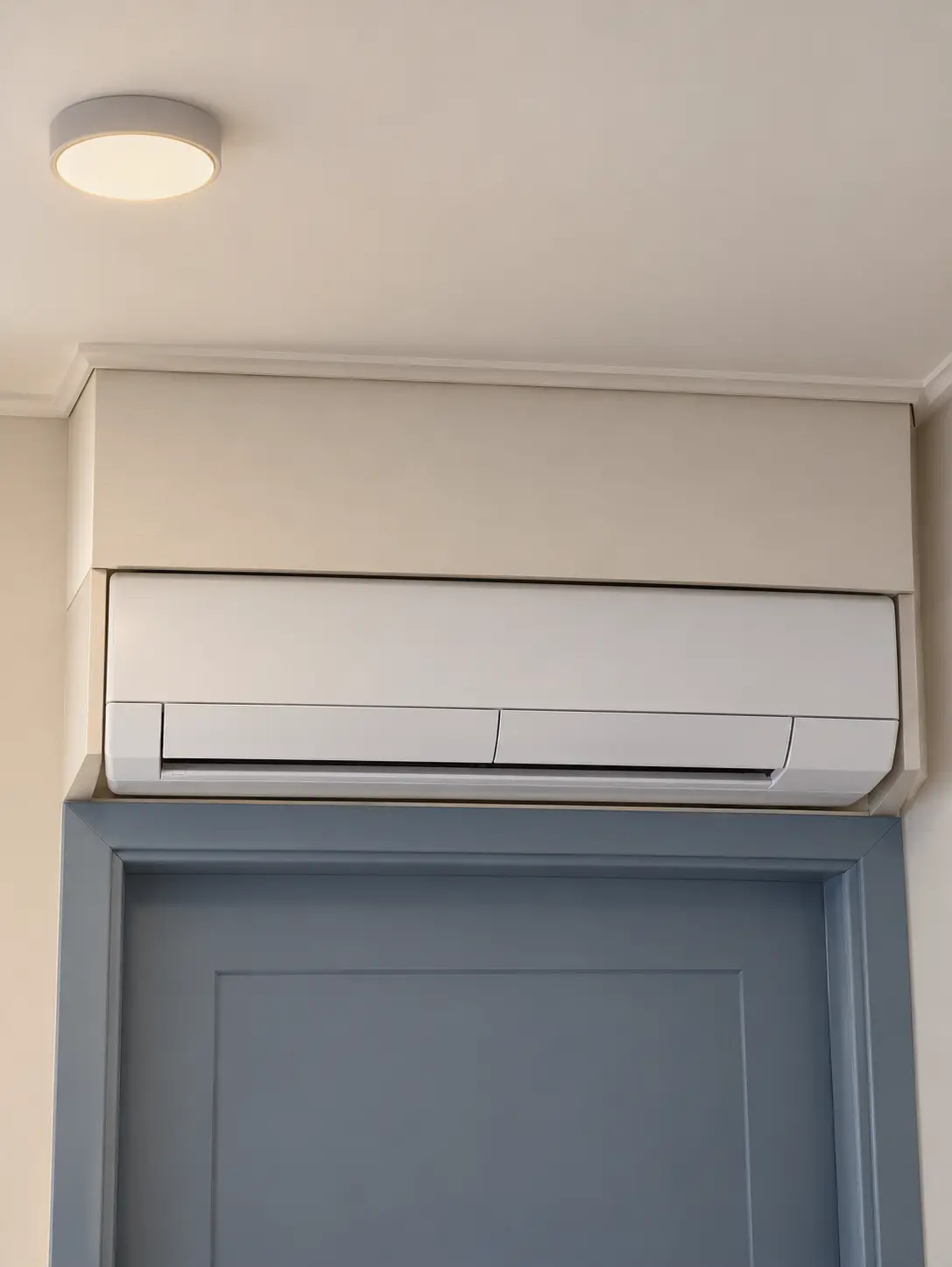 Example of an indoor heat-pump unit boxed in too tightly above a door